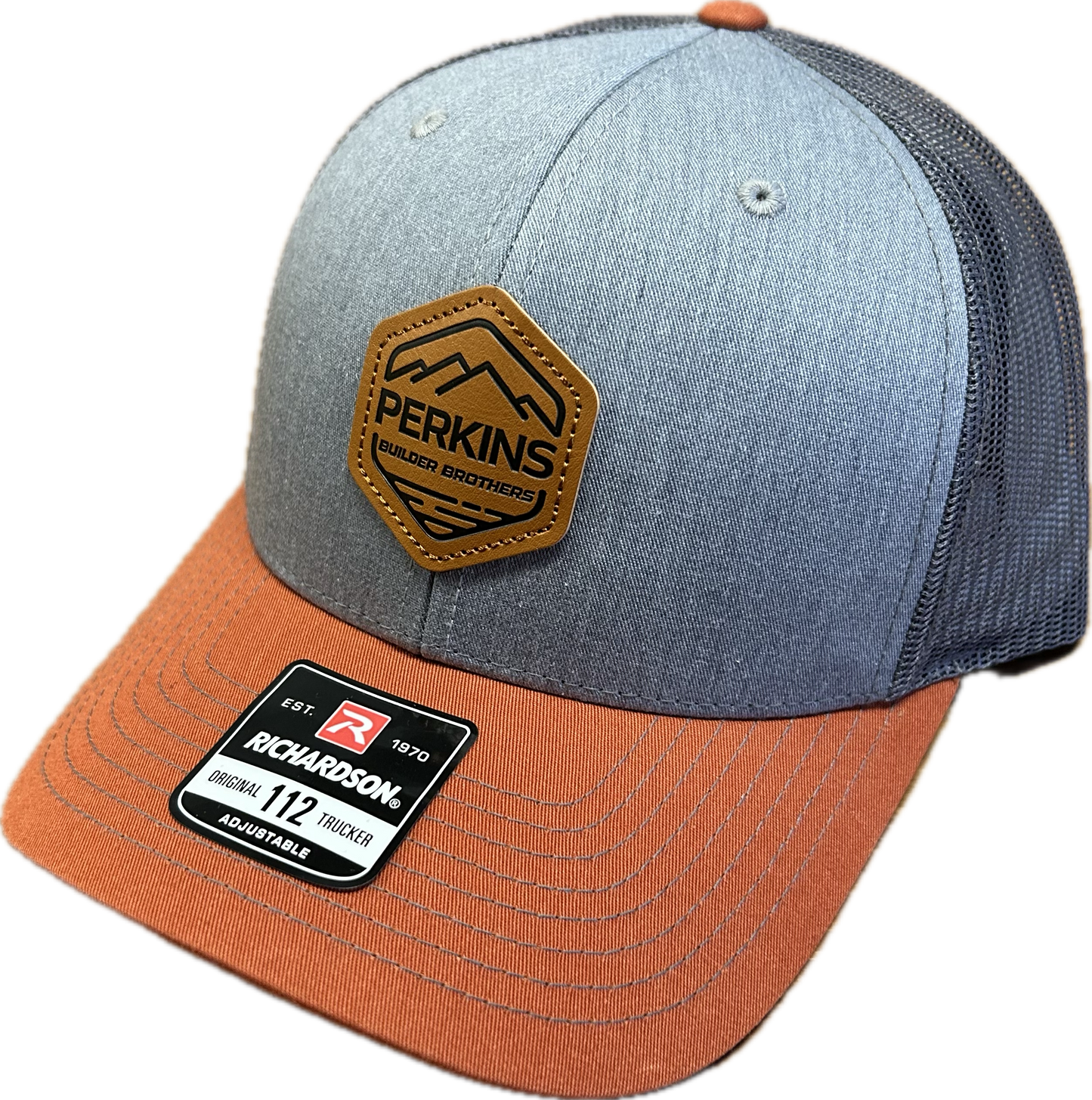 Genuine Leather Patch - Richardson 112 Snapback Trucker Hat - Grey/Charcoal/Dark Orange - Perkins Builder Brothers